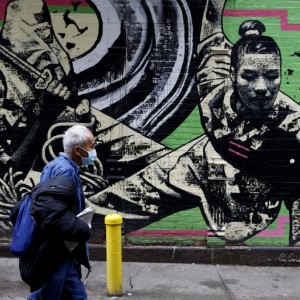 A man pass in front of graffiti in Chinatown on March 1, 2021, in New York City