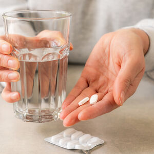 picture showing hands with water and medicine